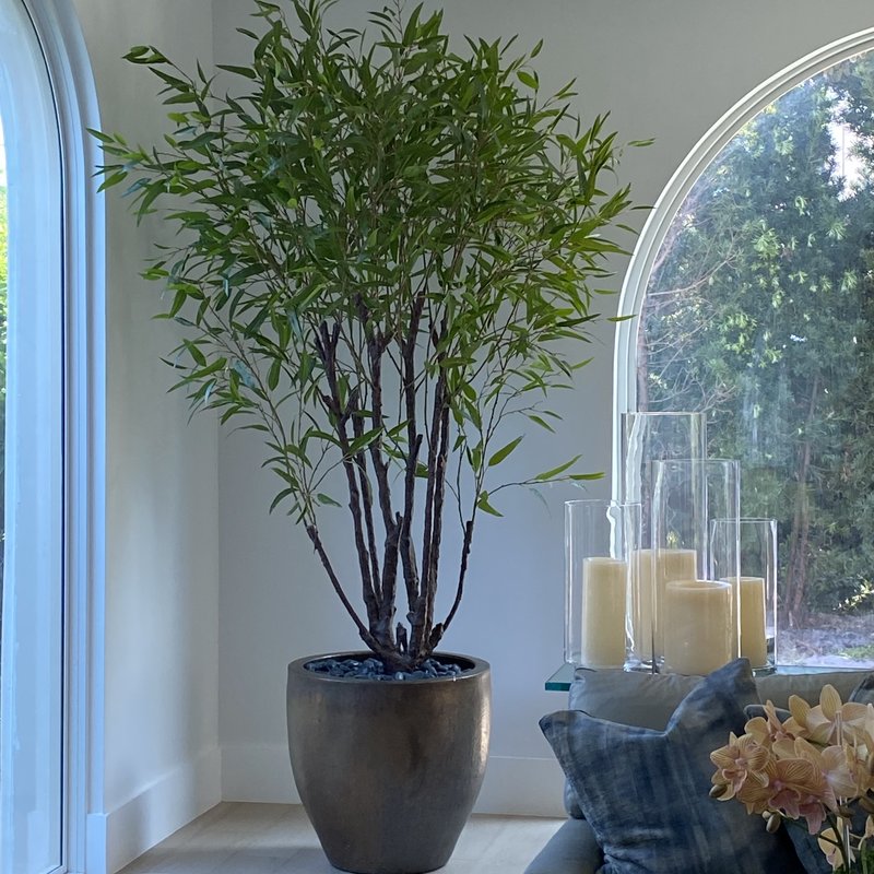 Tall artificial ficus tree in a pot